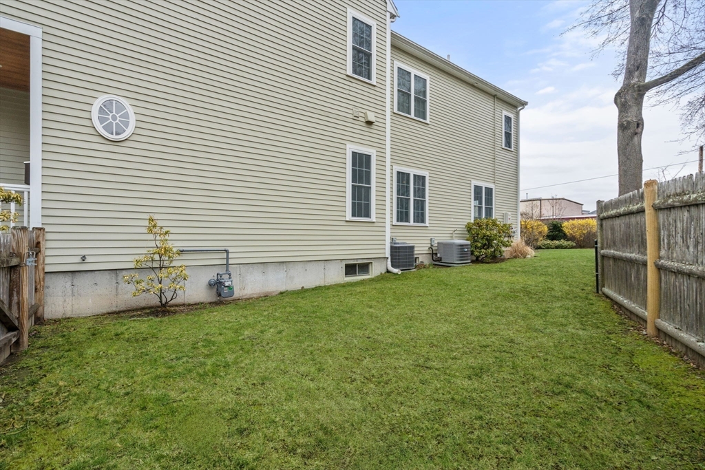 18 Maple Court, Unit 18 Needham, MA 02492 - Photo 24 of 25 a front view of a house with a yard and garage