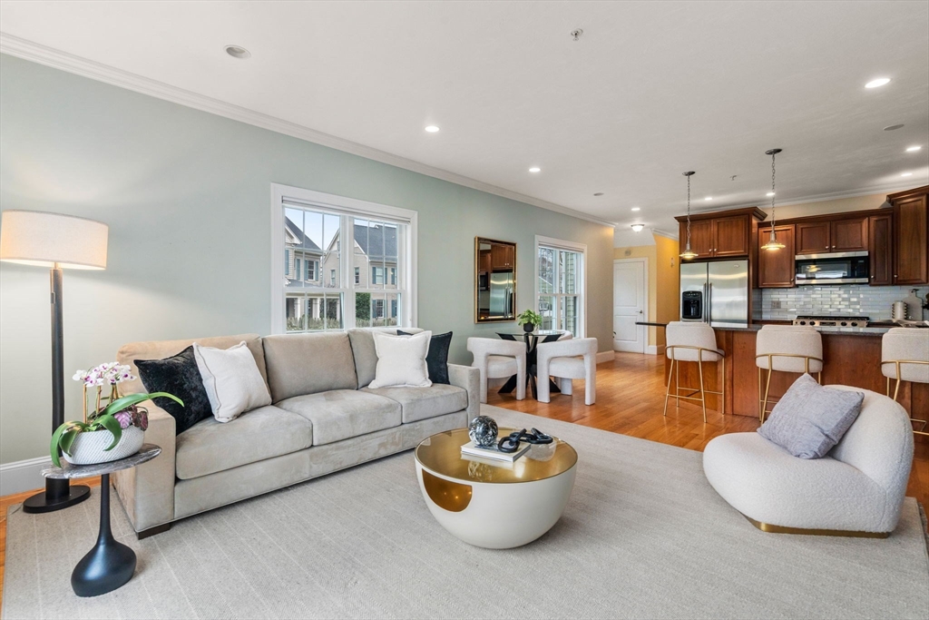 18 Maple Court, Unit 18 Needham, MA 02492 - Photo 3 of 25 a living room with furniture and a wooden floor