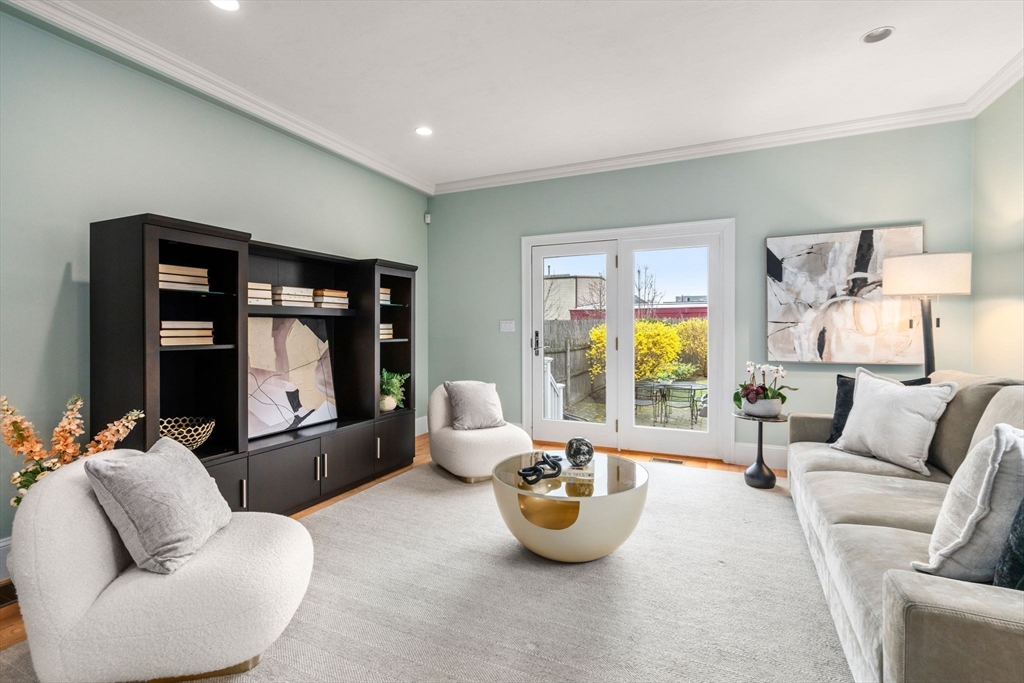 18 Maple Court, Unit 18 Needham, MA 02492 - Photo 4 of 25 a living room with furniture and a large window