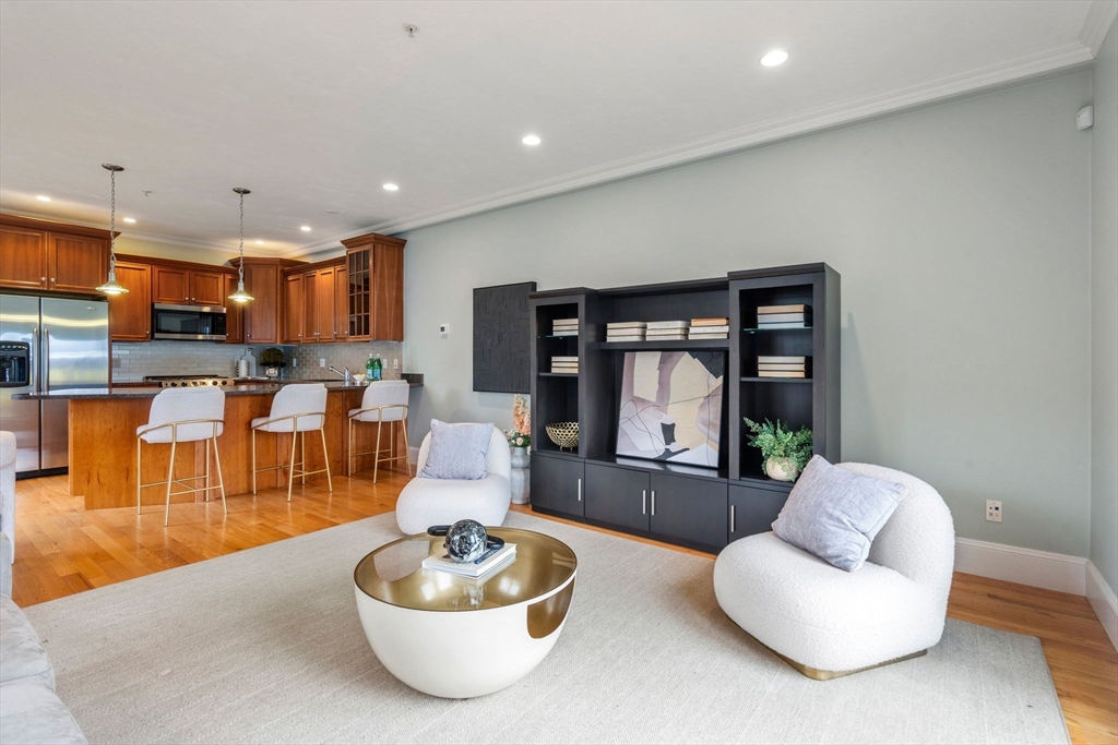 18 Maple Court, Unit 18 Needham, MA 02492 - Photo 5 of 25 a living room with furniture and a large window