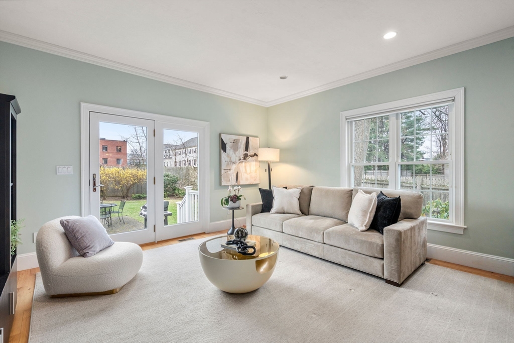 18 Maple Court, Unit 18 Needham, MA 02492 - Photo 6 of 25 a living room with furniture and a large window