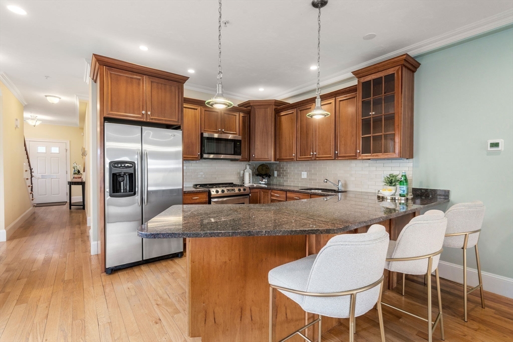 18 Maple Court, Unit 18 Needham, MA 02492 - Photo 9 of 25 a large kitchen with granite countertop lots of counter top space