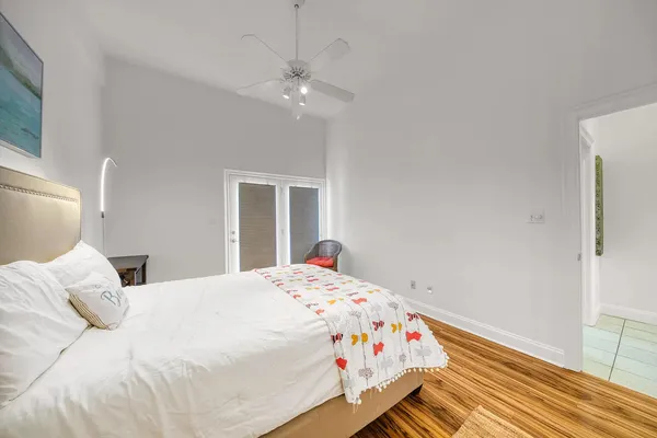 a bedroom with a bed and wooden floor