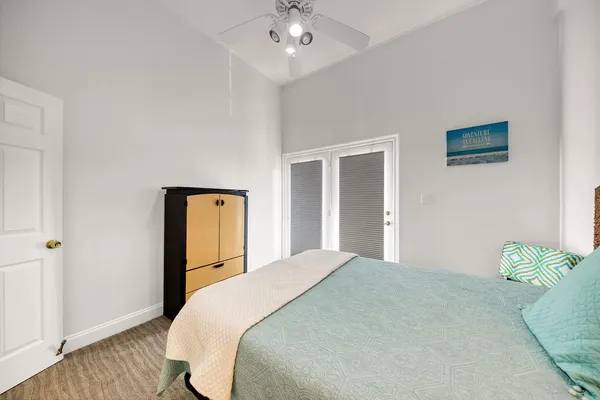 a bedroom with a bed and a chandelier