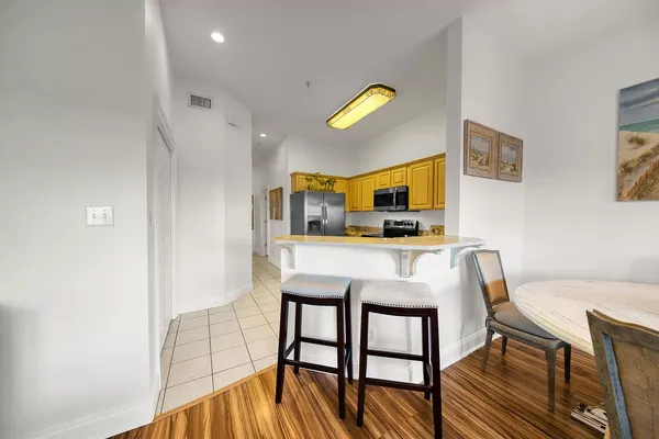 a view of a dining room with furniture and a window