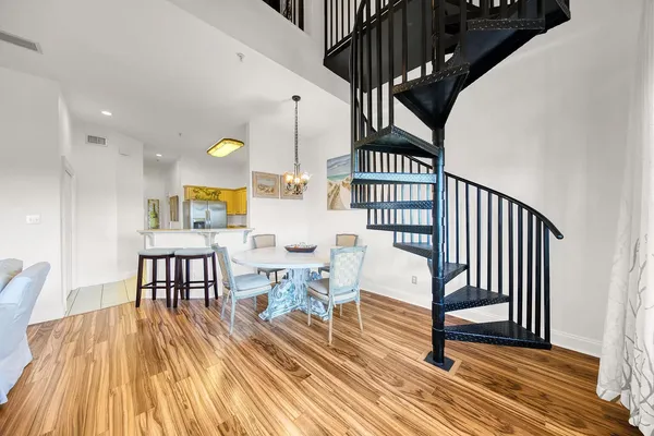 a view of dining room with furniture and wooden floor
