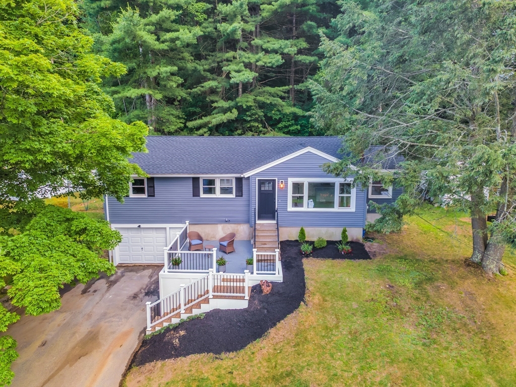 33 Ontario Drive Hudson, MA 01749 - Photo 2 of 36 a aerial view of a house with table and chairs under an umbrella