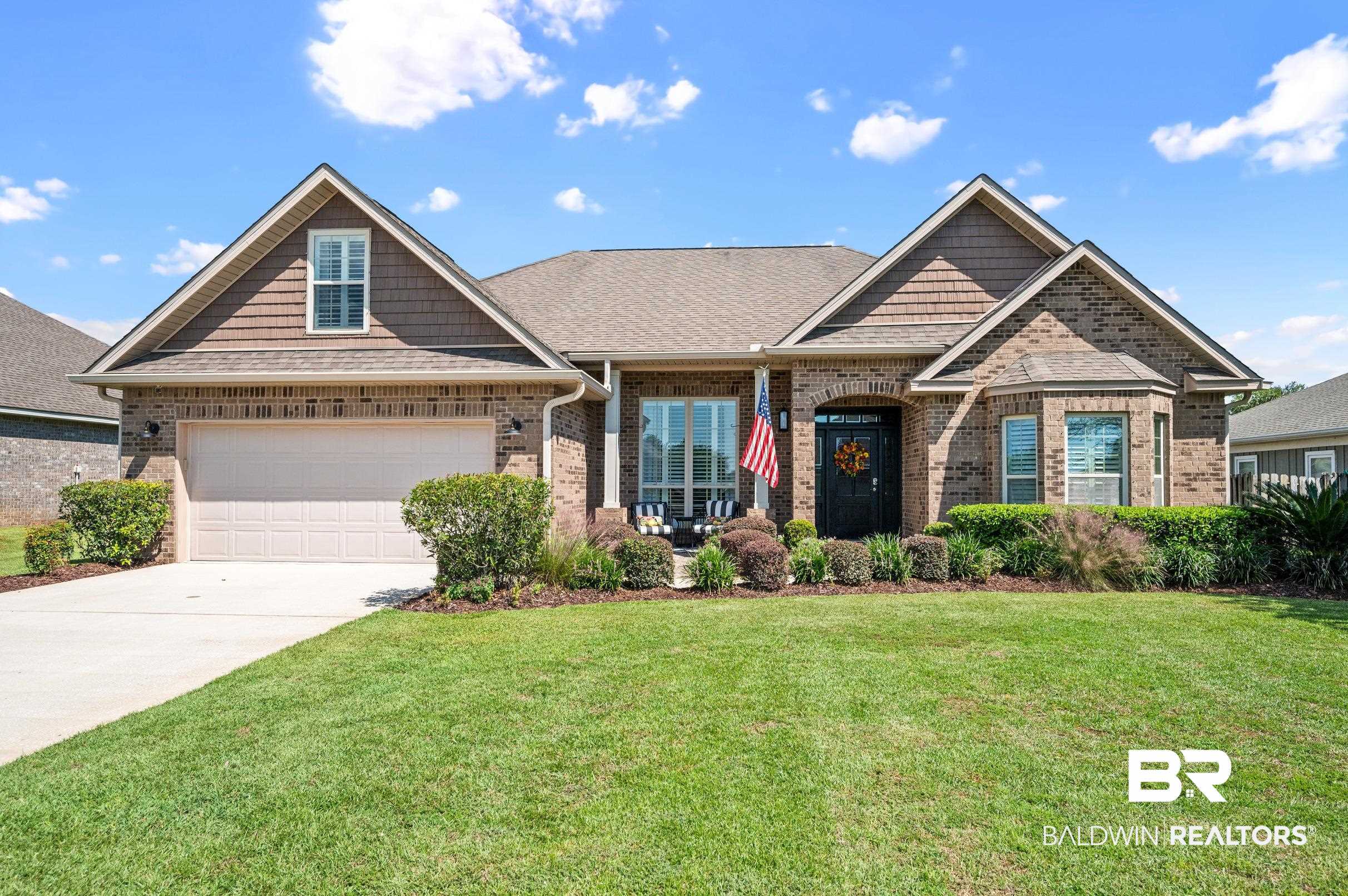 7012 Rocky Rd Loop Gulf Shores, AL 36542 - Photo 1 of 66 Craftsman-style house featuring a front lawn and a garage