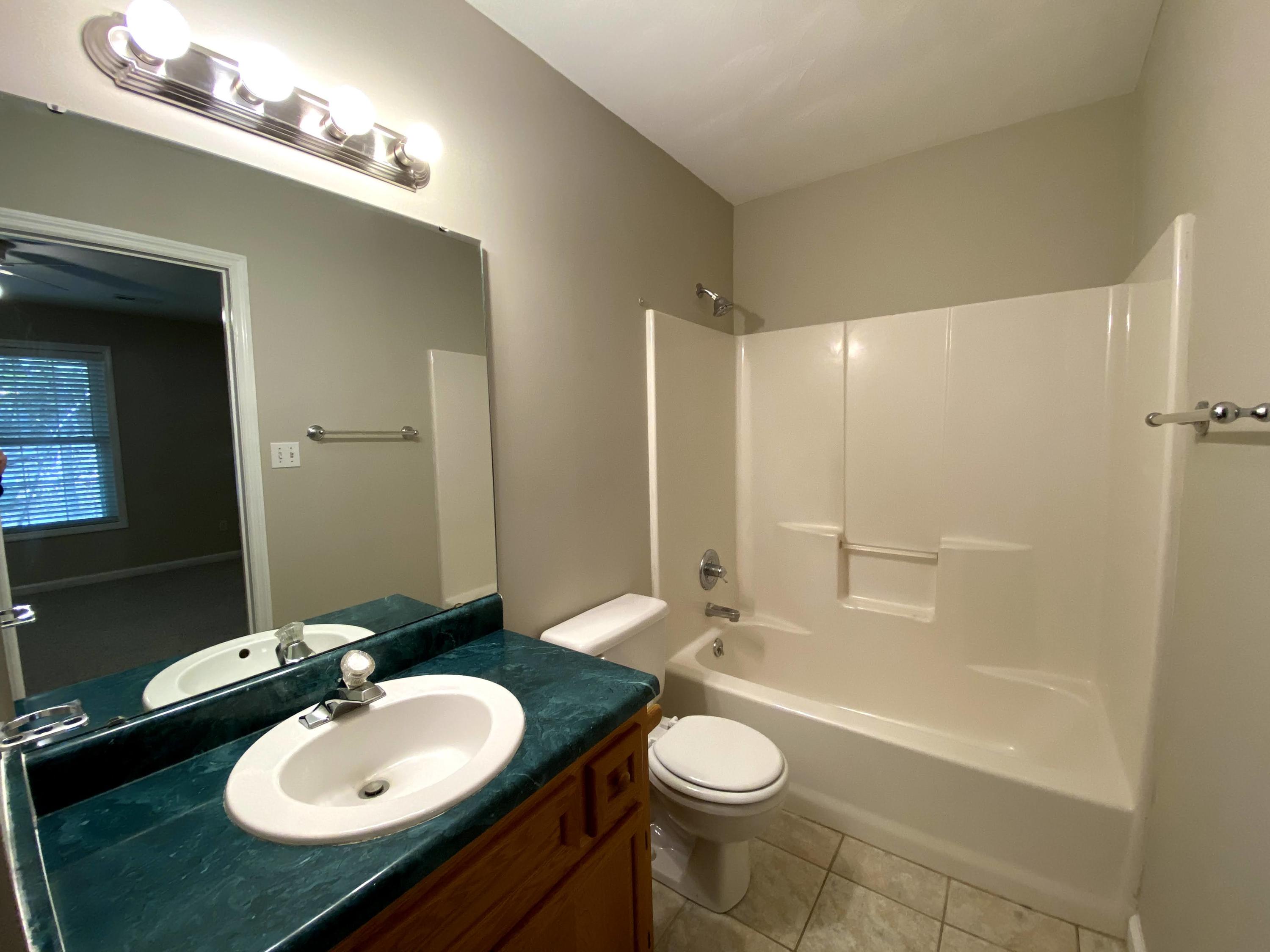 35 Silver Lake Road Hardy, VA 24101 - Photo 33 of 47 a bathroom with a sink a toilet a mirror and shower