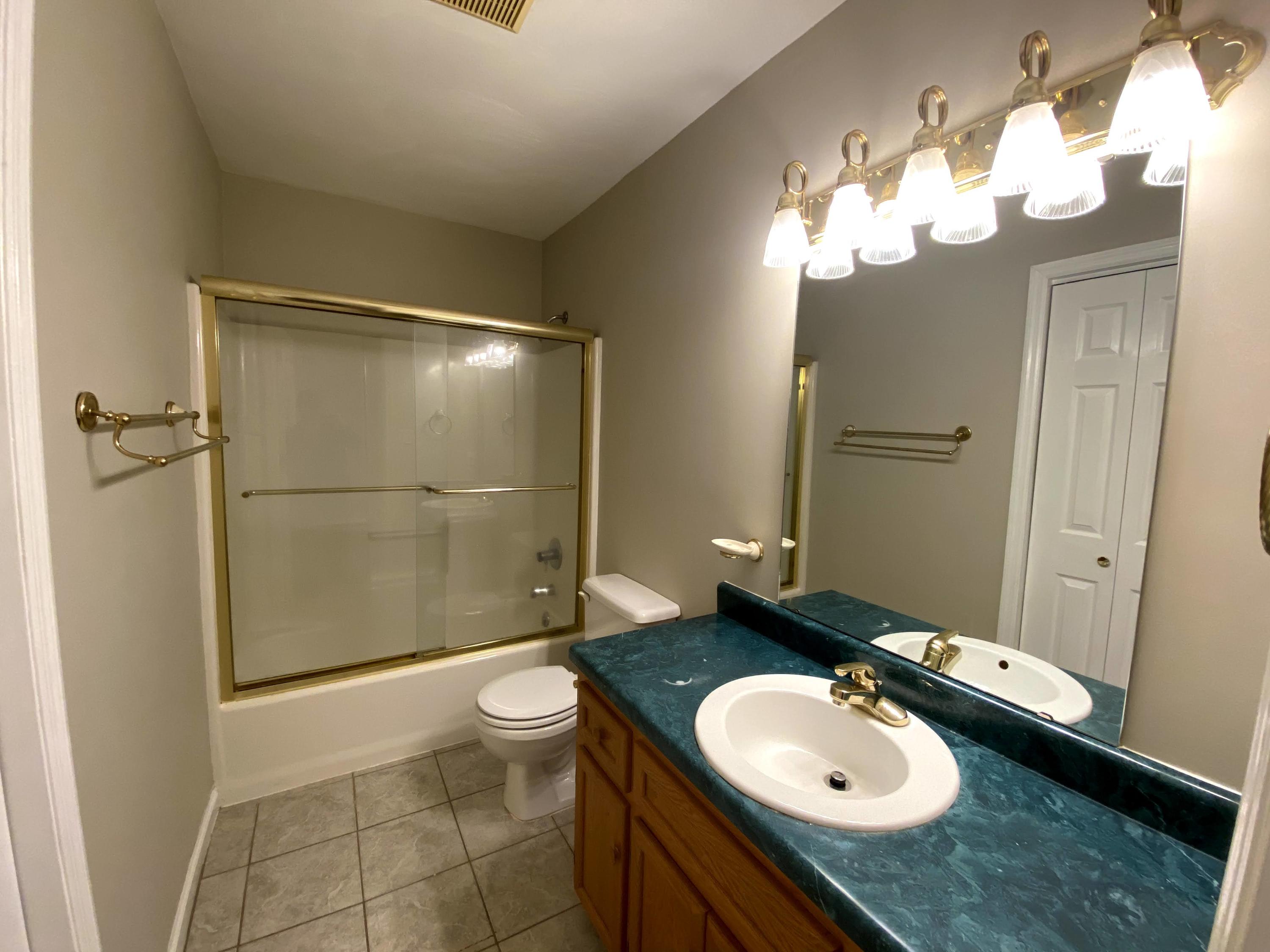 35 Silver Lake Road Hardy, VA 24101 - Photo 43 of 47 a bathroom with a granite countertop sink toilet mirror and shower