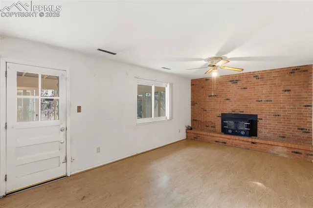 a view of an empty room with a fireplace