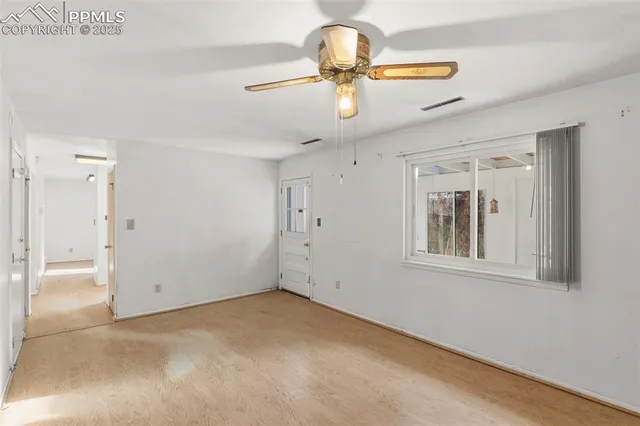 a view of a livingroom with a ceiling fan and window