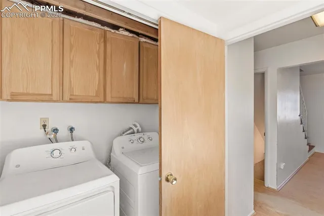 a view of storage and utility room with washer and dryer