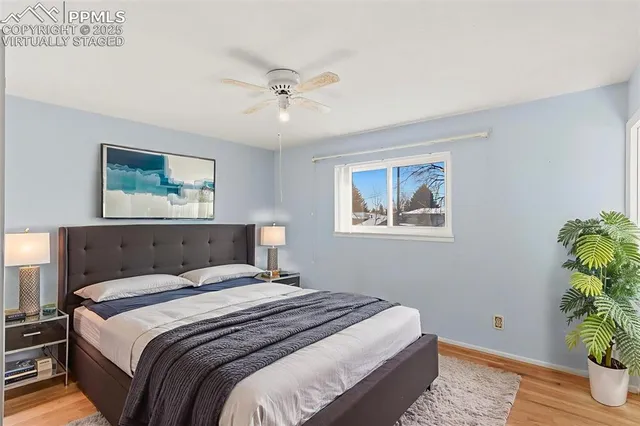 a bedroom with a bed and a potted plant