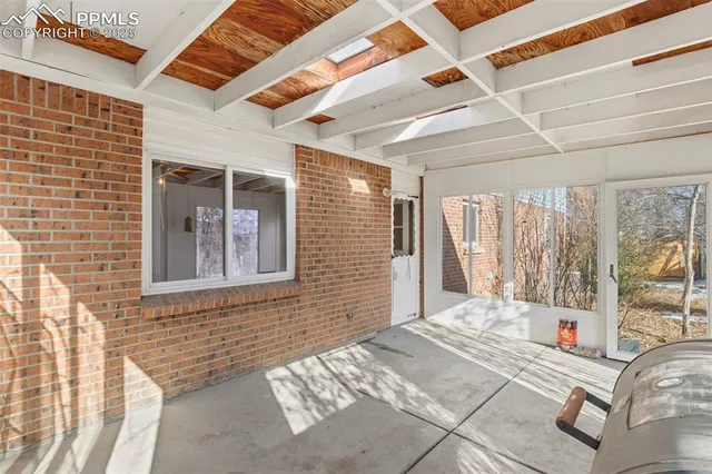 a view of a porch with a table and chairs