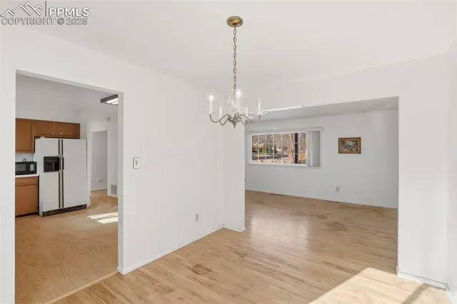 a view of a room with window and kitchen view