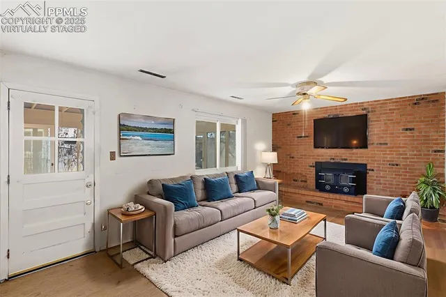 a living room with fireplace furniture and a flat screen tv