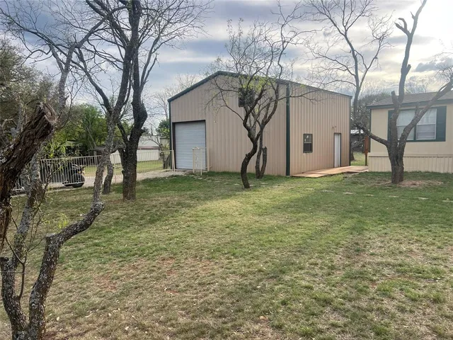 a white house that has a tree in front of it
