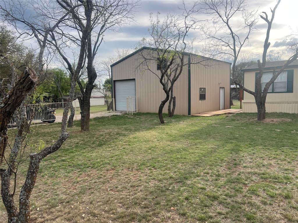 3370 Surfside Drive May, TX 76857 - Photo 2 of 28 a white house that has a tree in front of it