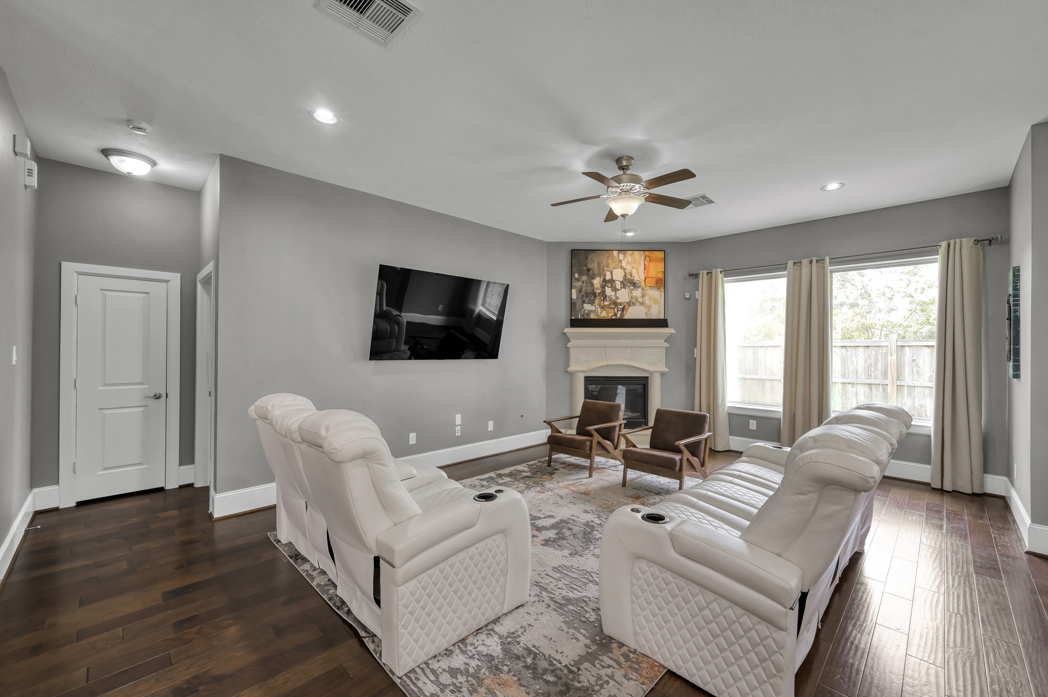 31714 Pierwood Court Spring, TX 77386 - Photo 14 of 49 a living room with furniture a ceiling fan a flat screen tv and a large window