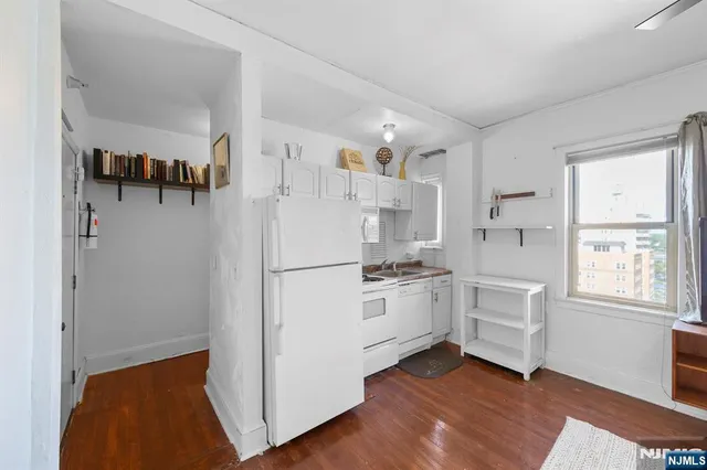 a kitchen with white cabinets and white appliances
