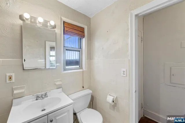 a bathroom with a toilet a sink and mirror