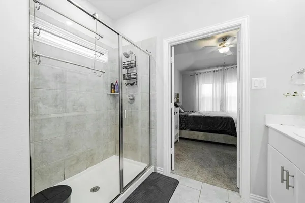 a bathroom with a tub shower and sink