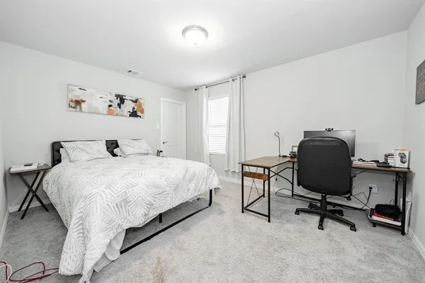 a bedroom with a bed and chair