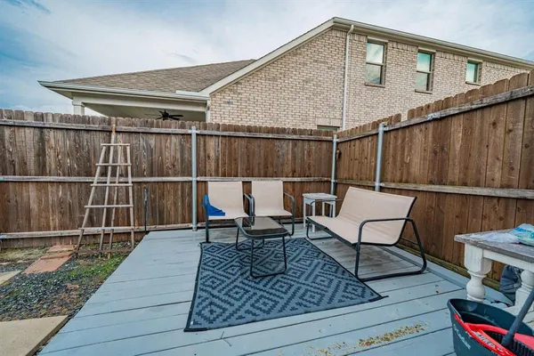 a roof deck with table and chairs