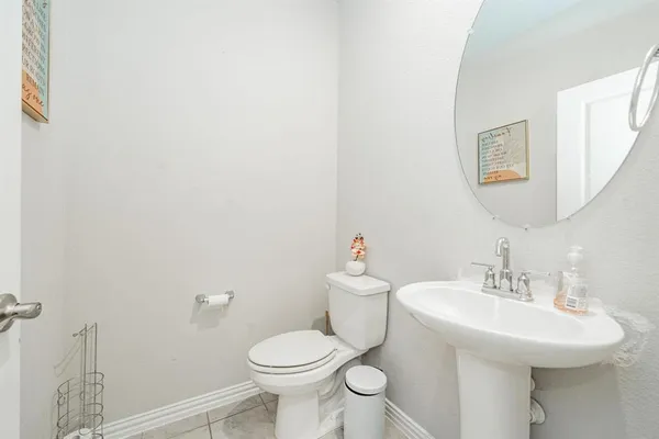 a bathroom with a sink mirror and toilet