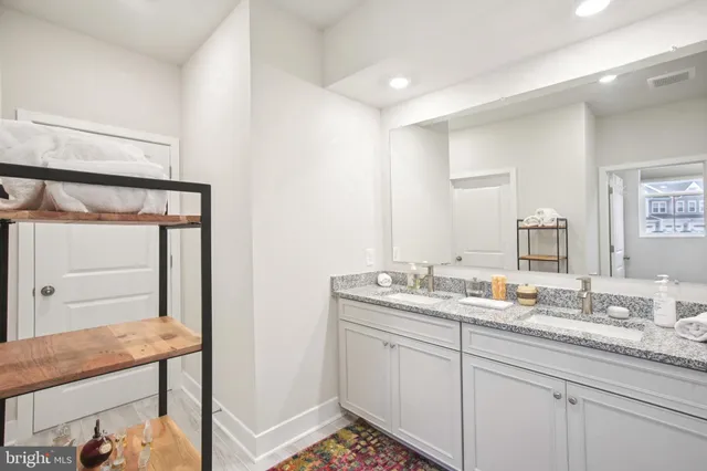 a en suite bathroom with a sink mirror and