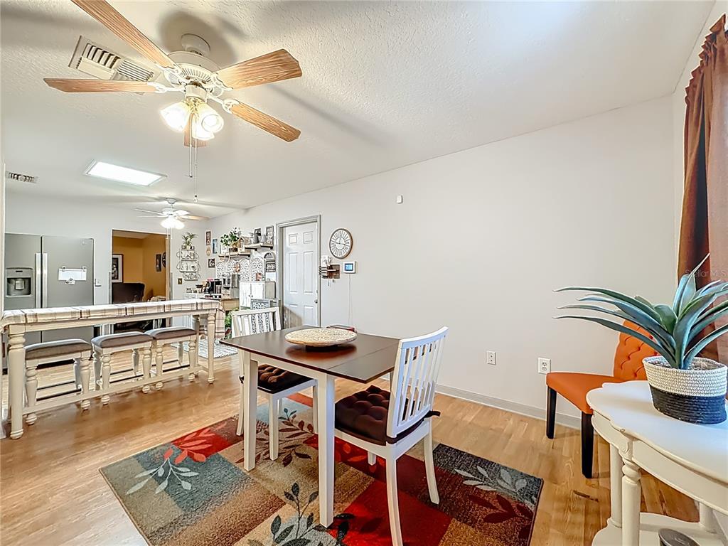 457 North Rooks Avenue Inverness, FL 34453 - Photo 13 of 61 a view of a dining room with furniture and wooden floor