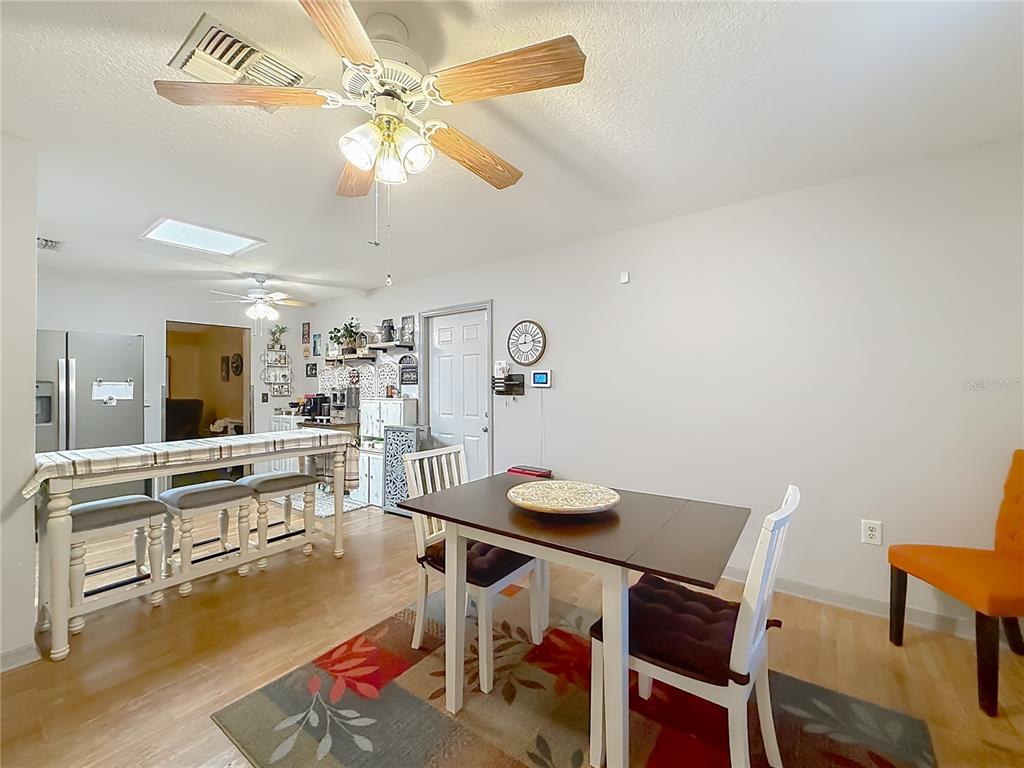 457 North Rooks Avenue Inverness, FL 34453 - Photo 14 of 61 a view of a dining room with furniture and wooden floor