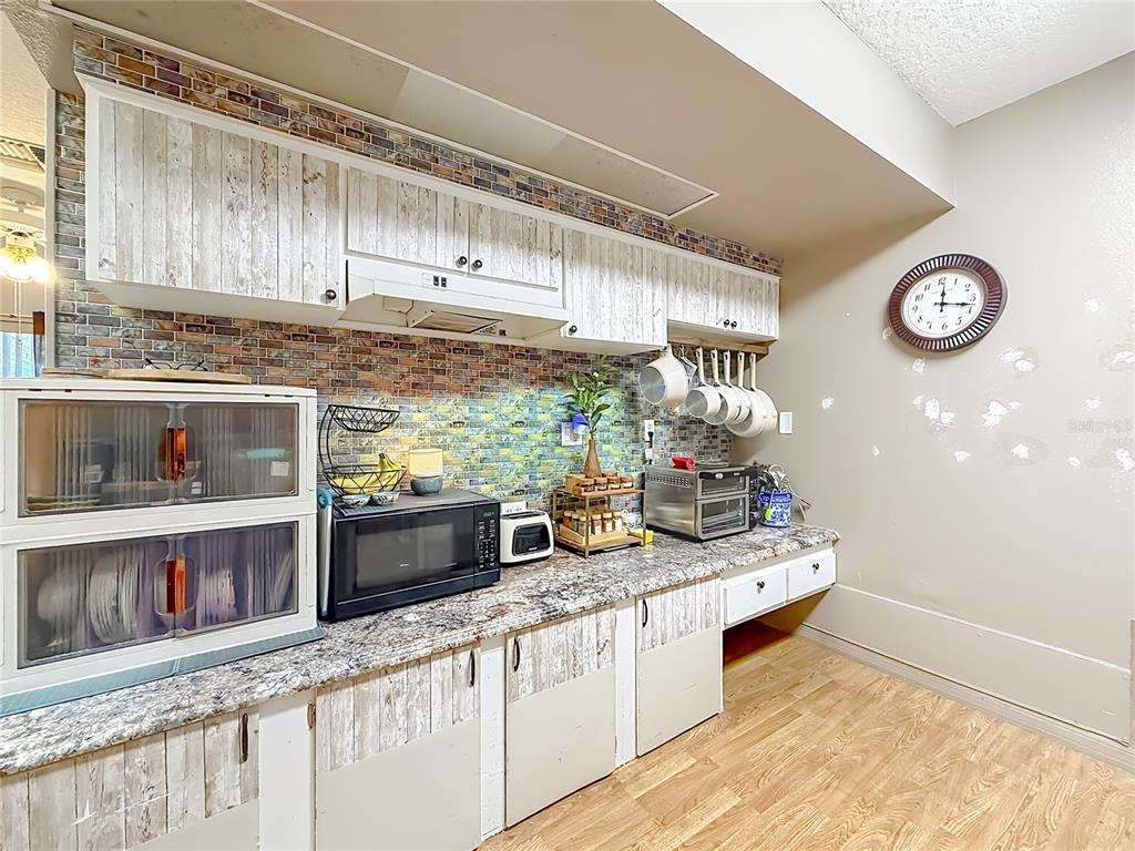 457 North Rooks Avenue Inverness, FL 34453 - Photo 19 of 61 a kitchen with stainless steel appliances granite countertop a stove a sink and a microwave