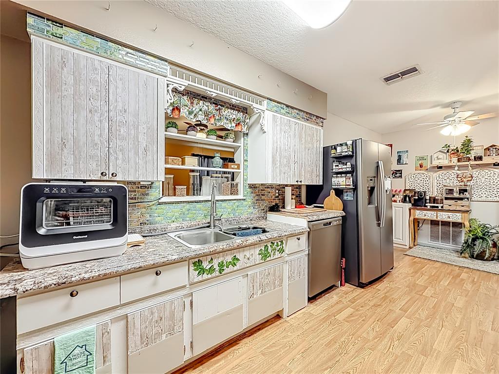 457 North Rooks Avenue Inverness, FL 34453 - Photo 21 of 61 a kitchen with a stove a sink and a microwave