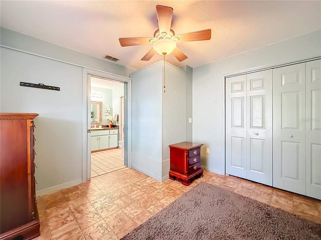 457 North Rooks Avenue Inverness, FL 34453 - Photo 24 of 61 a view of a bedroom with cabinet cabinet and a chandelier fan