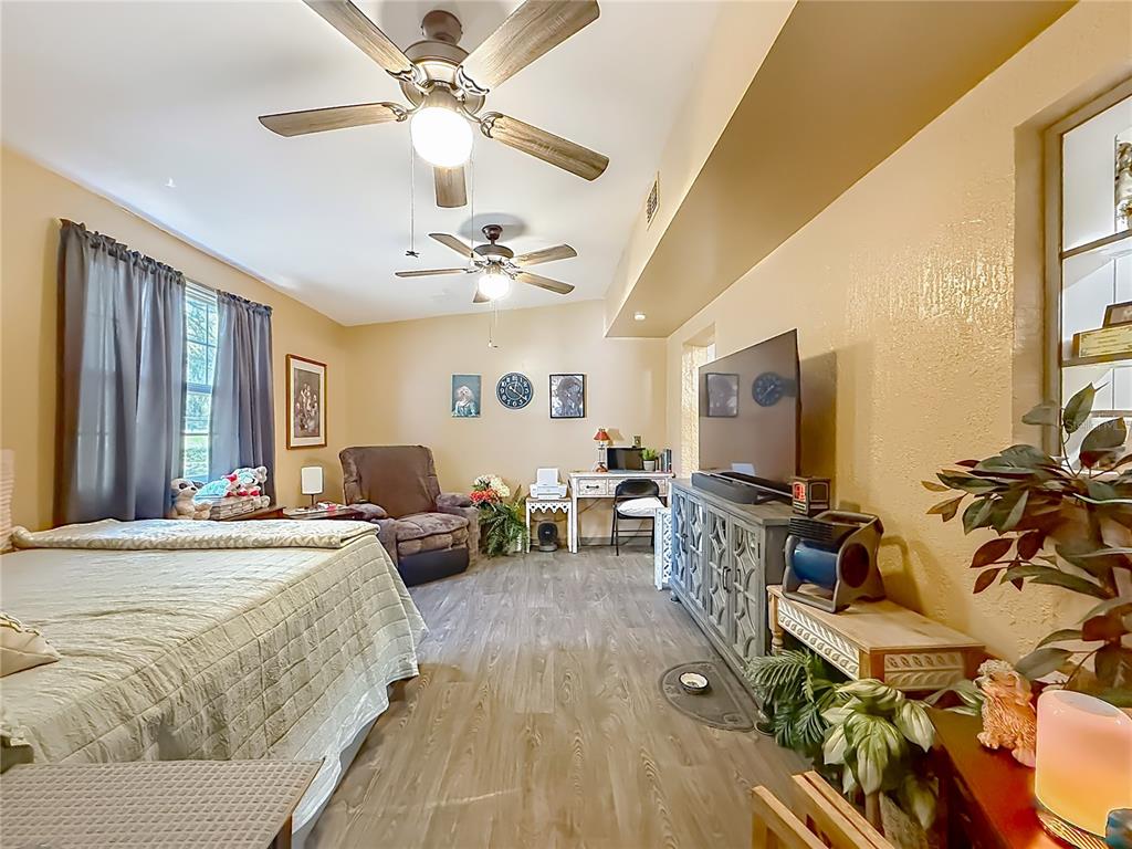 457 North Rooks Avenue Inverness, FL 34453 - Photo 28 of 61 a bedroom with furniture a flat screen tv and a ceiling fan