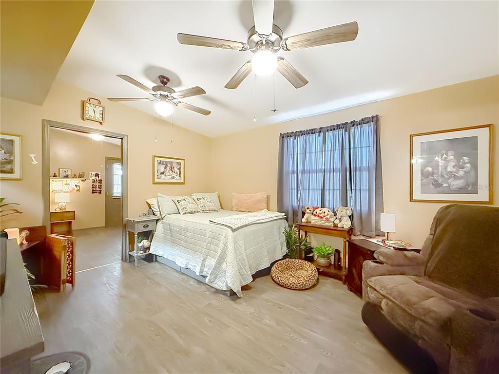 457 North Rooks Avenue Inverness, FL 34453 - Photo 30 of 61 a spacious bedroom with a bed mirror and couch