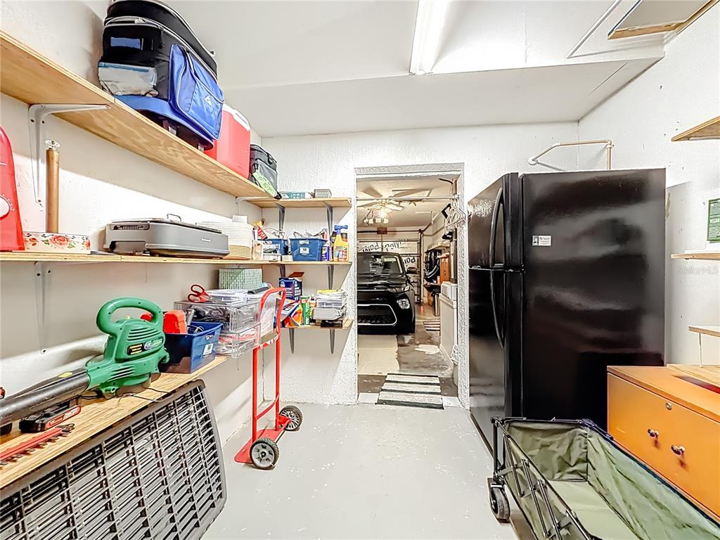 457 North Rooks Avenue Inverness, FL 34453 - Photo 40 of 61 a storage room with washer and lots of stuff