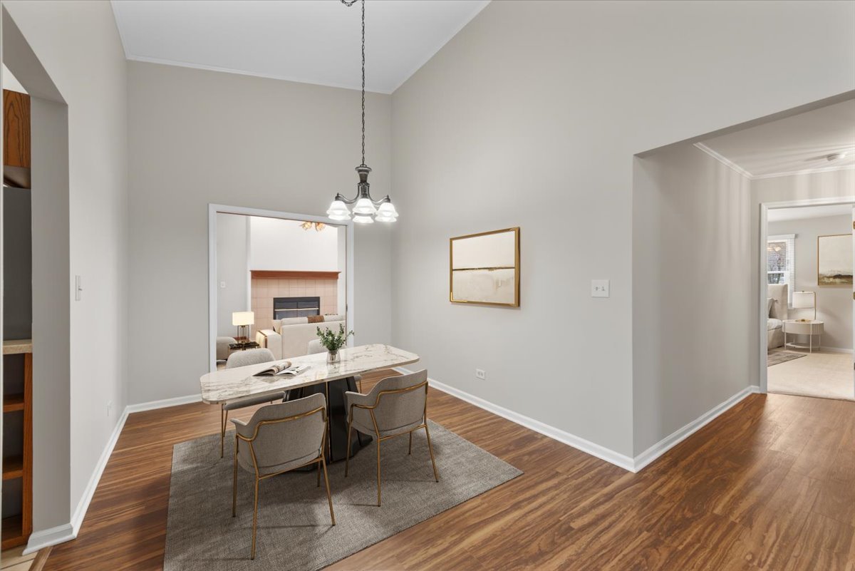 1095 Devonshire Avenue Naperville, IL 60540 - Photo 12 of 48 a view of a dining room with furniture a chandelier and wooden floor