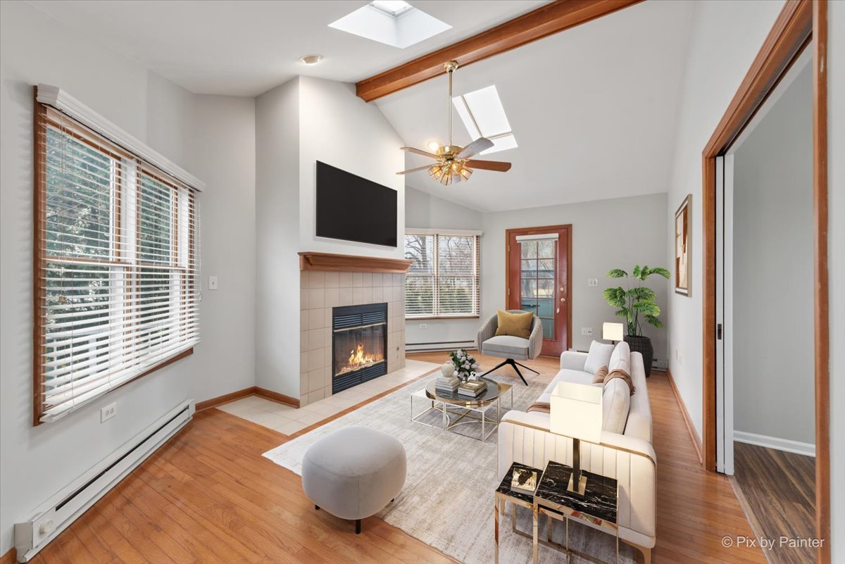 1095 Devonshire Avenue Naperville, IL 60540 - Photo 21 of 48 a living room with furniture a fireplace and a flat screen tv
