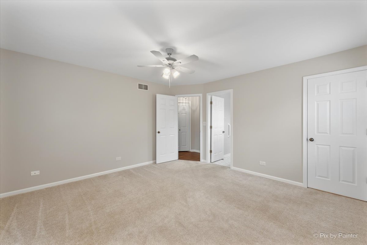 1095 Devonshire Avenue Naperville, IL 60540 - Photo 30 of 48 a view of an empty room with a ceiling fan