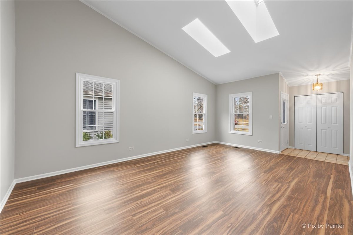 1095 Devonshire Avenue Naperville, IL 60540 - Photo 8 of 48 wooden floor in an empty room with a window