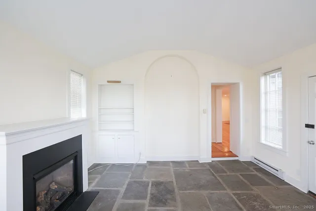 a view of an empty room and fire place