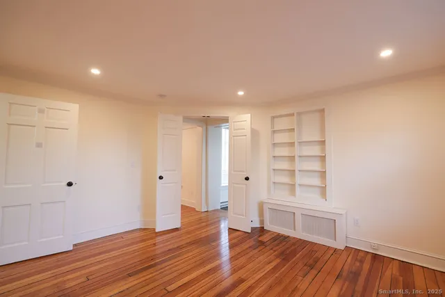 a view of room with wooden floor and window
