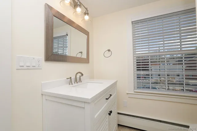 a bathroom with a sink a vanity and a window