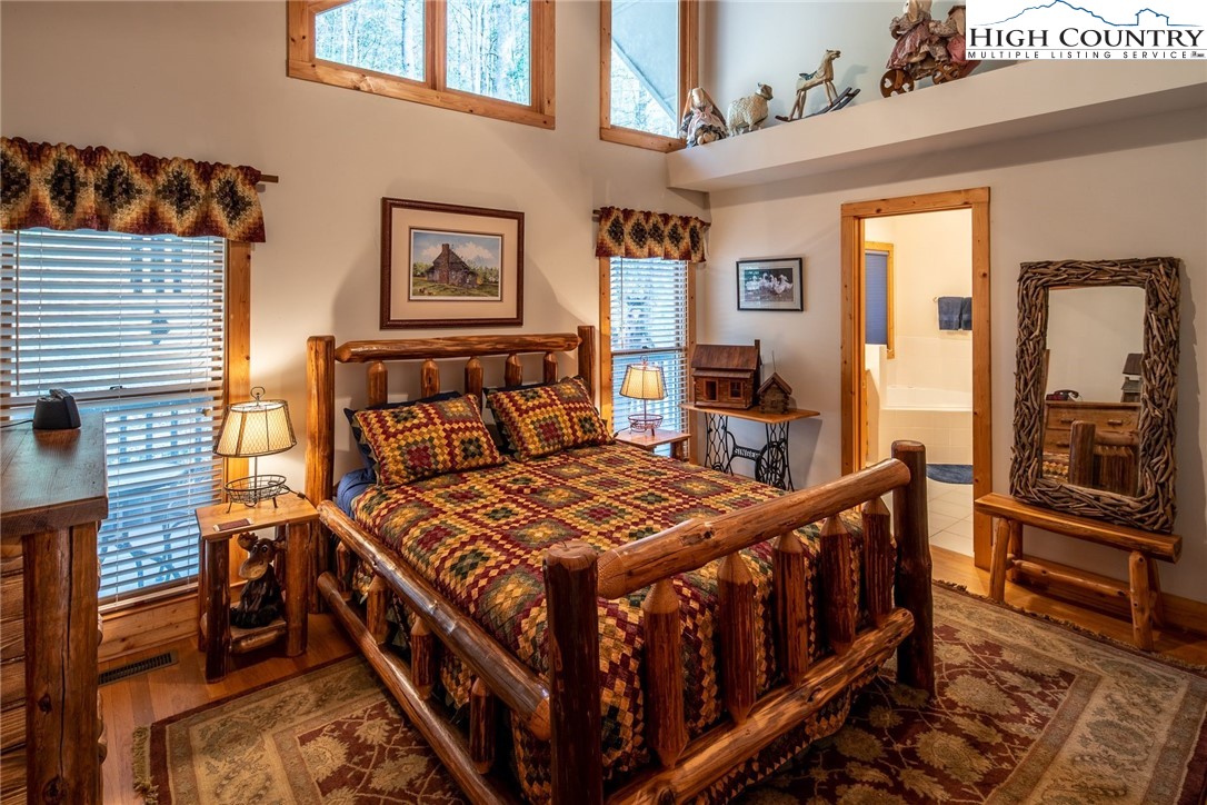 1278 Meadow Road Ferguson, NC 28624 - Photo 13 of 38 a bedroom with a bed and wooden floor