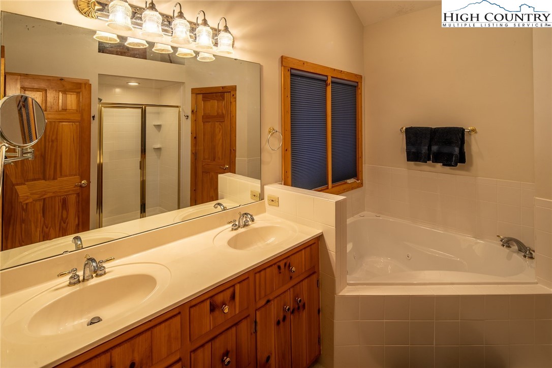 1278 Meadow Road Ferguson, NC 28624 - Photo 17 of 38 a bathroom with a sink a large mirror and a bathtub