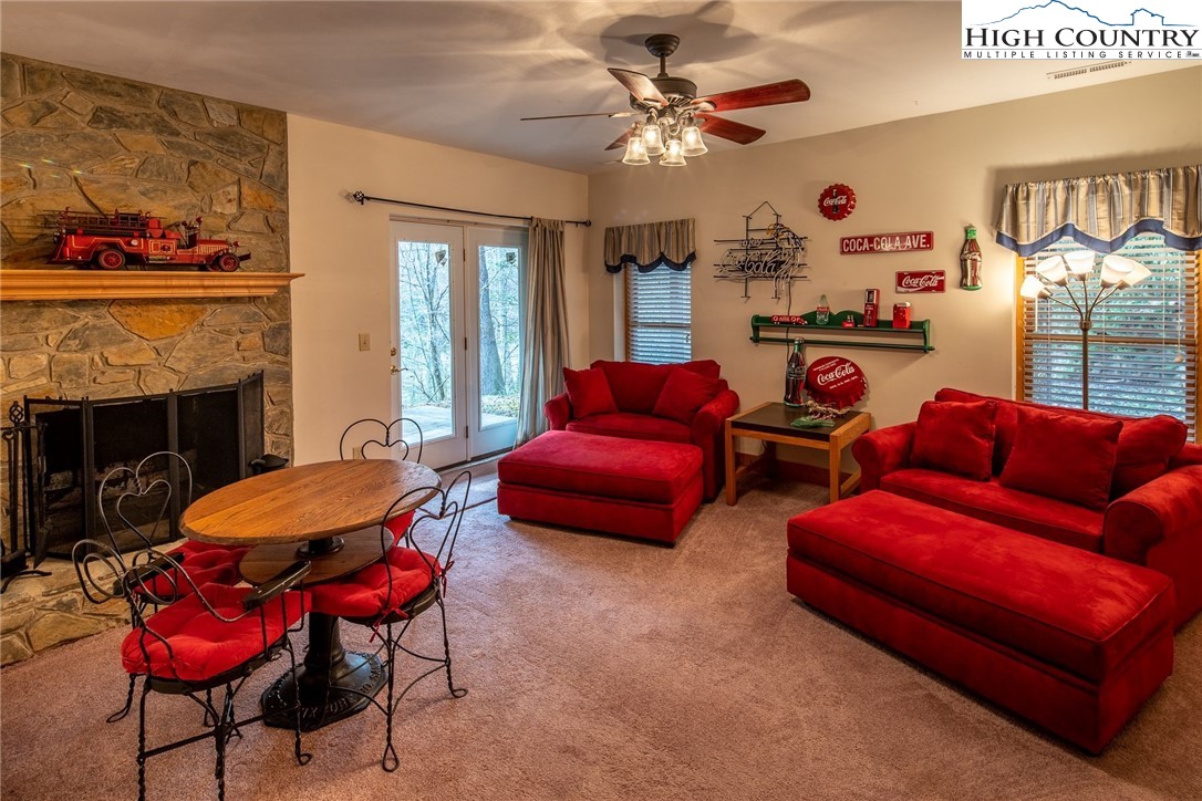 1278 Meadow Road Ferguson, NC 28624 - Photo 19 of 38 a living room with furniture a fireplace and a flat screen tv