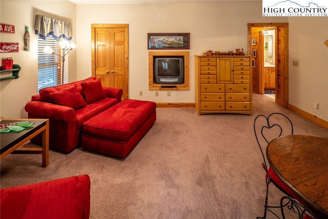 1278 Meadow Road Ferguson, NC 28624 - Photo 20 of 38 a living room with furniture a flat screen tv and a table